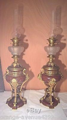 A pair of french ormulu-mounted red marble oil lamp circa 1890