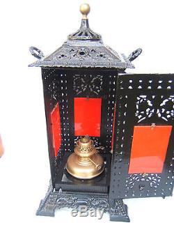 Antique Cathedral stove with brass rising oil lamp. Cast iron oil lamp