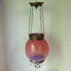Antique ornate brass hanging hall oil lamp fixture with pink opalescent swirl s