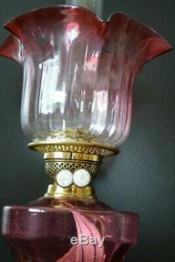 Victorian twin burner oil lamp. Cranberry font and shade