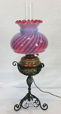 Vintage antique banquet parlor oil lamp with cranberry swirl design shade